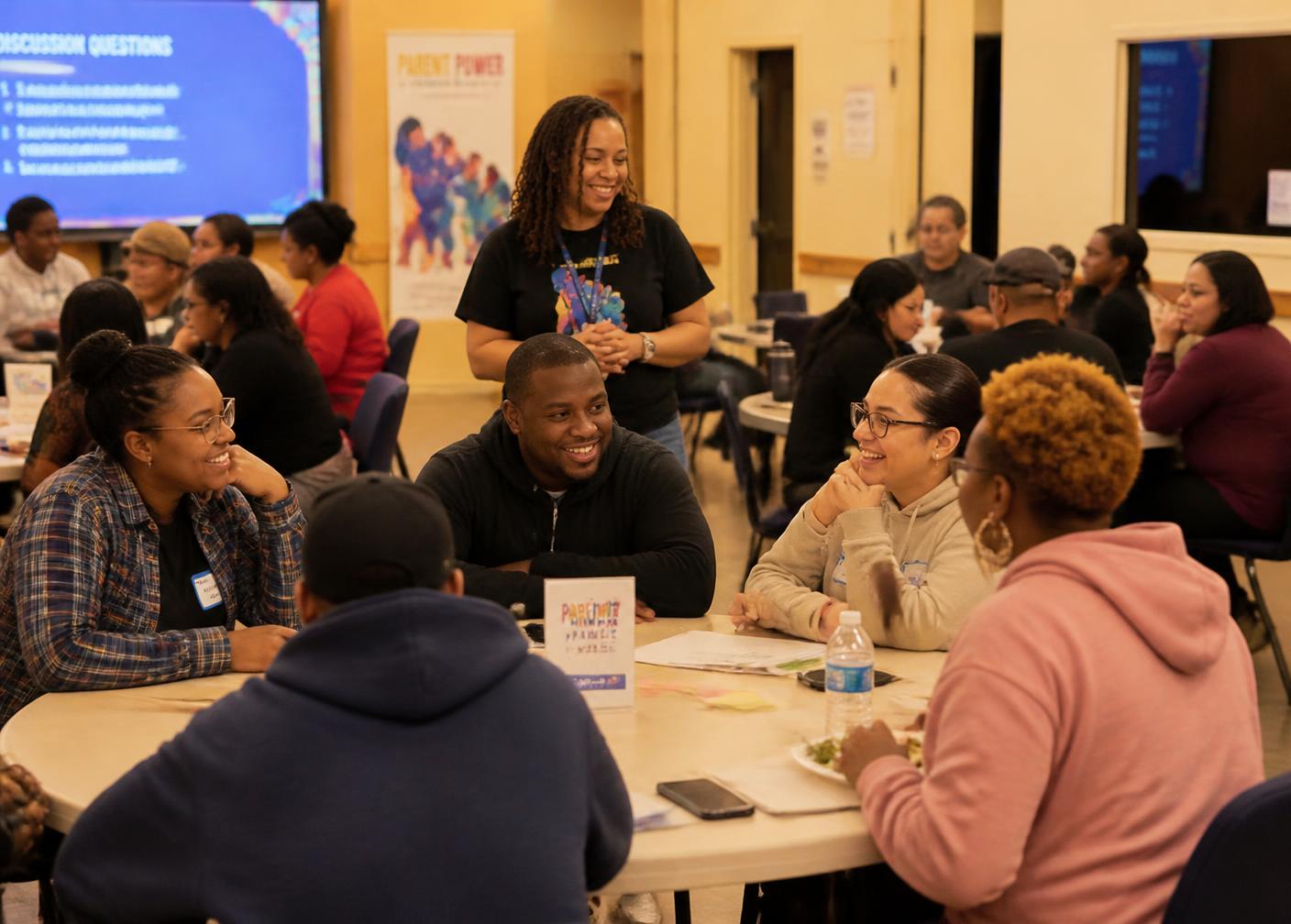 Parents and caregivers talking together at a community family workshop